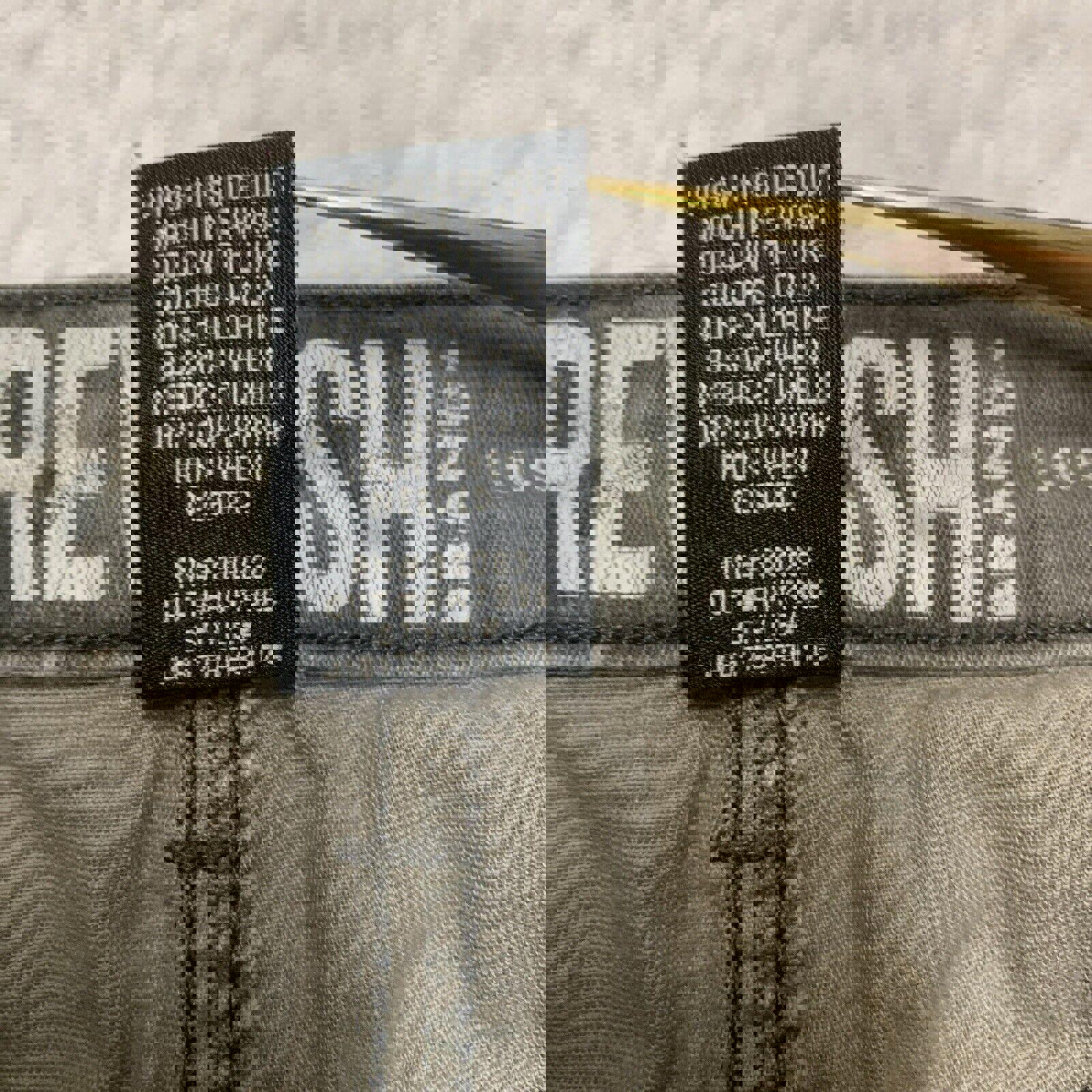 Pantalones rectos con estampado de camuflaje verde oliva para niños de la marca Rewash, talla 7/28